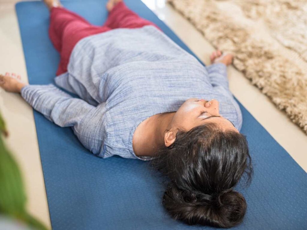 lying down on a yoga mat