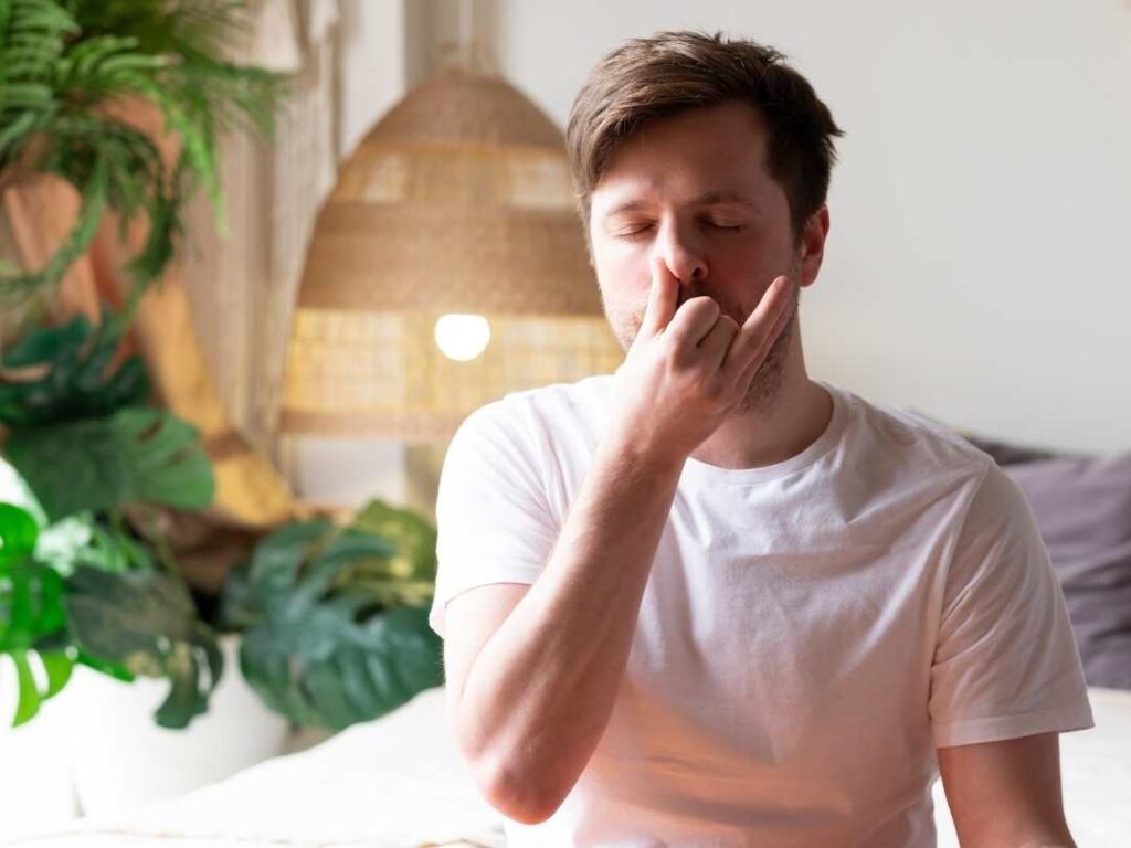 man doing alternate nose breathing